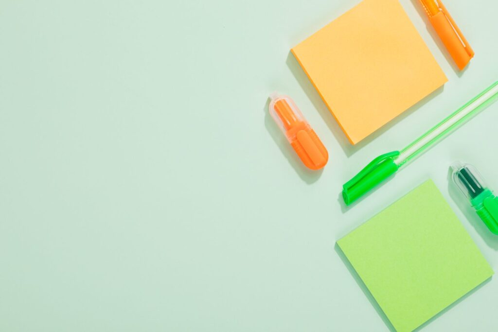 Bright back-to-school stationery arranged on a green background